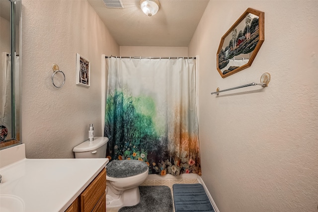 bathroom featuring toilet, a textured ceiling, vanity, and tile patterned floors