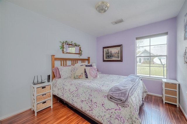 bedroom featuring multiple windows and hardwood / wood-style flooring