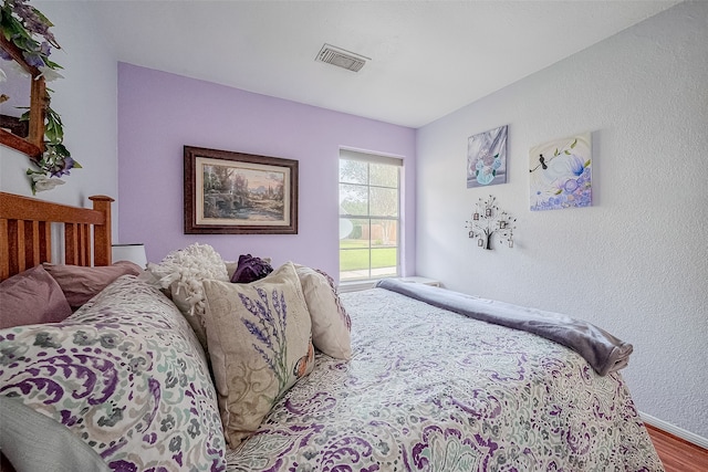 bedroom with hardwood / wood-style flooring