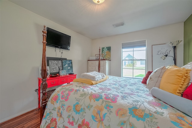 bedroom with hardwood / wood-style flooring