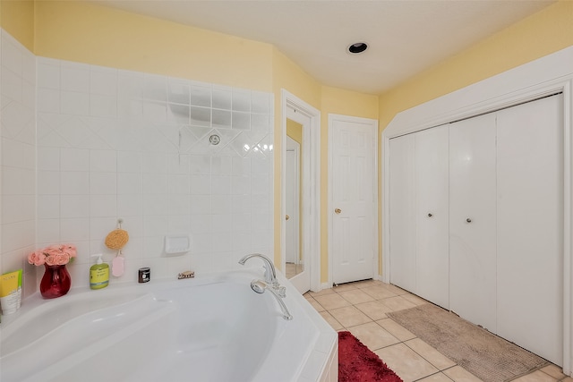 bathroom with a bathing tub and tile patterned floors