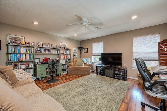 office area with a textured ceiling, ceiling fan, and dark hardwood / wood-style flooring