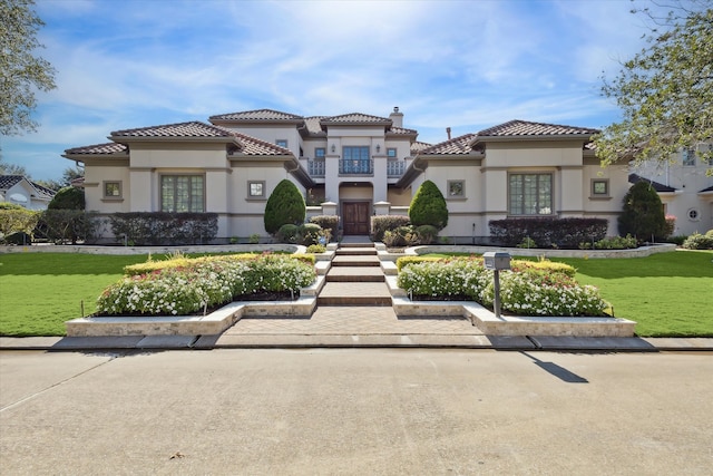 mediterranean / spanish home with a front yard