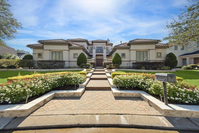 mediterranean / spanish-style house featuring a front lawn