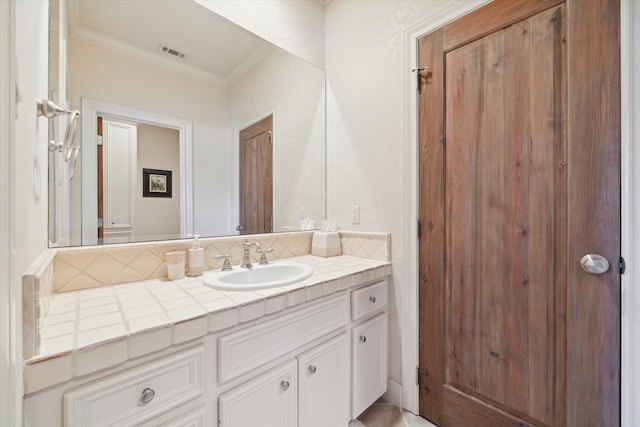 bathroom with vanity and crown molding