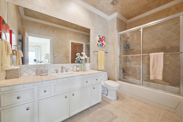 full bathroom featuring tile patterned floors, crown molding, vanity, and enclosed tub / shower combo