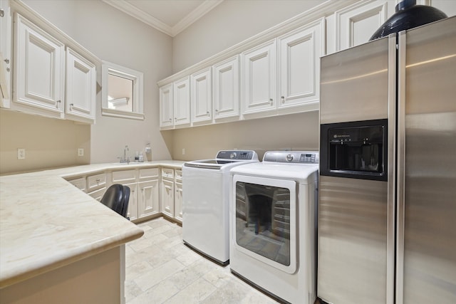 clothes washing area featuring cabinets, separate washer and dryer, ornamental molding, and sink