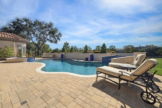 view of pool with an in ground hot tub and a patio