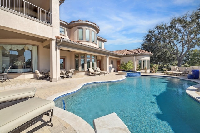 view of pool featuring an in ground hot tub and a patio