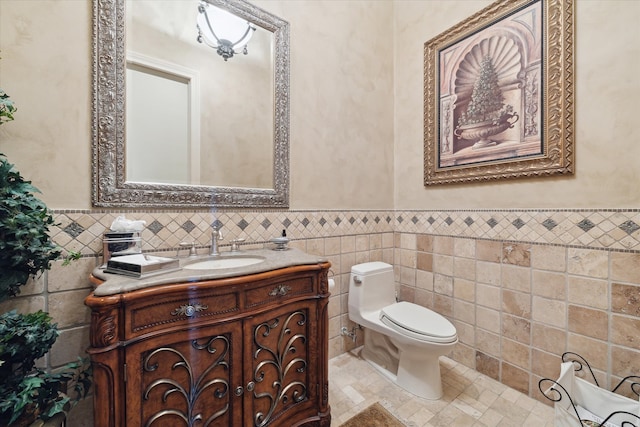 bathroom featuring vanity, toilet, and tile walls