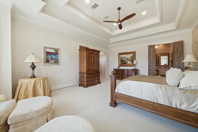 bedroom featuring light carpet, a tray ceiling, ceiling fan, and ornamental molding