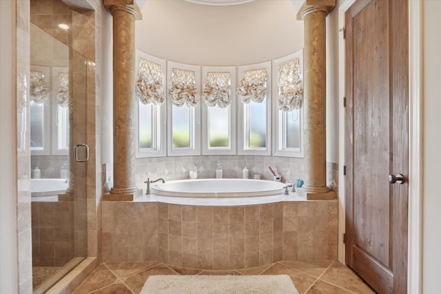 bathroom featuring tile patterned floors, ornate columns, and shower with separate bathtub