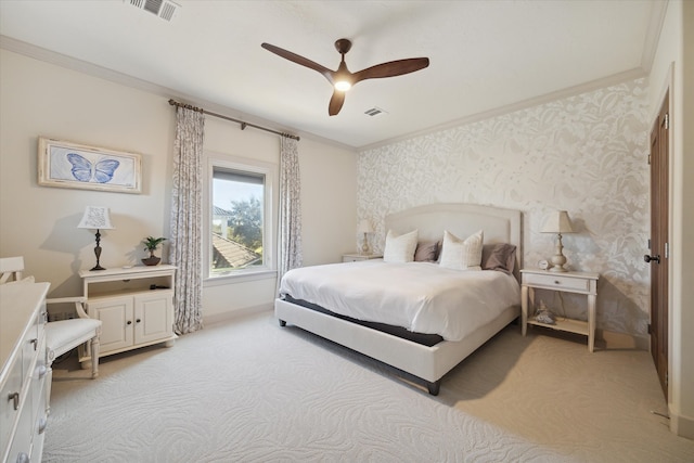 bedroom with ceiling fan, ornamental molding, and light carpet