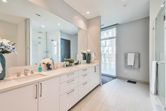 bathroom featuring vanity, tile patterned floors, and an enclosed shower