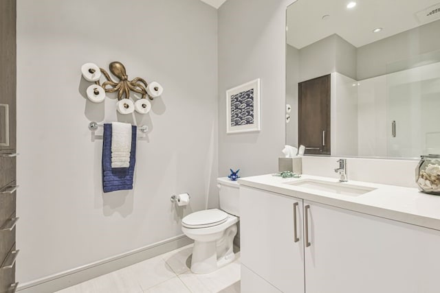 bathroom with vanity, tile patterned floors, toilet, and walk in shower