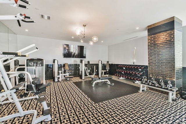 exercise room featuring a chandelier