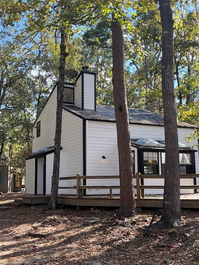 back of house with a wooden deck