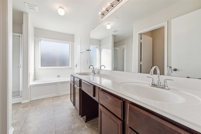 bathroom with vanity and independent shower and bath