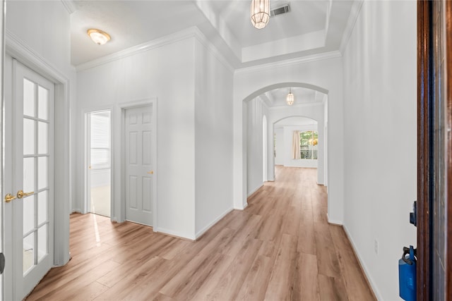 hallway with crown molding and light wood-type flooring