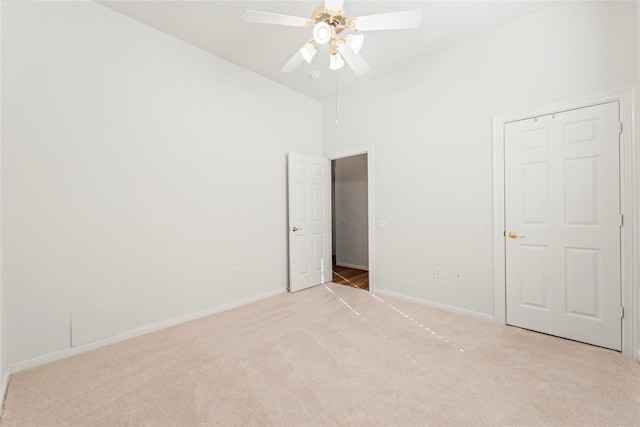 23 Wilmington Way, Conroe, TX 77384 - unfurnished bedroom featuring light colored carpet, high vaulted ceiling, baseboards, and a ceiling fan