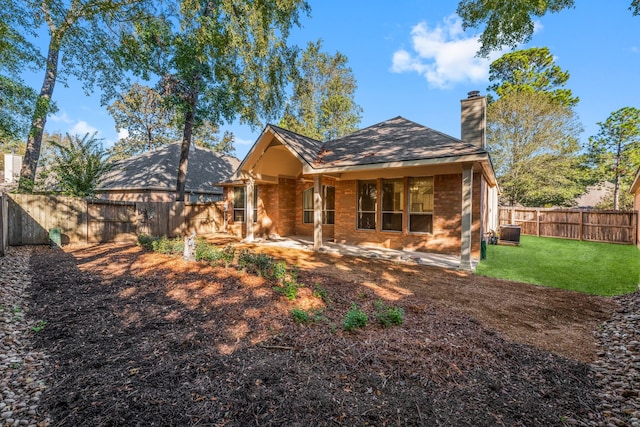 rear view of house featuring a patio, a lawn, and central air condition unit