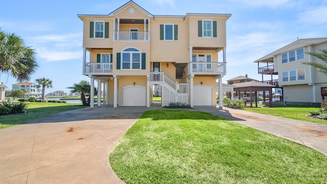 view of front of house featuring a balcony, a garage, and a front lawn