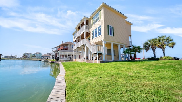 exterior space featuring a yard and a water view