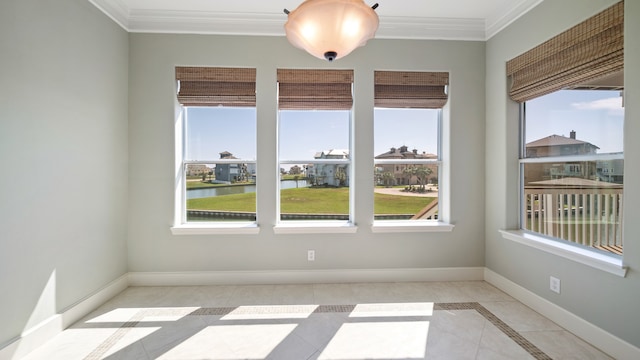 unfurnished room featuring ornamental molding, a water view, and light tile patterned floors