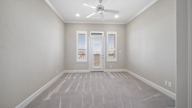 spare room with ceiling fan, light carpet, and ornamental molding