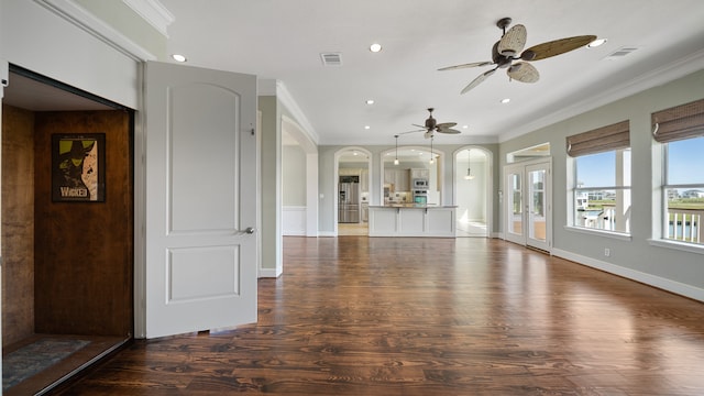 unfurnished living room with ornamental molding, dark hardwood / wood-style floors, and ceiling fan