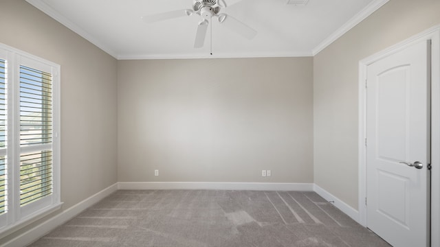 carpeted empty room with ornamental molding and ceiling fan