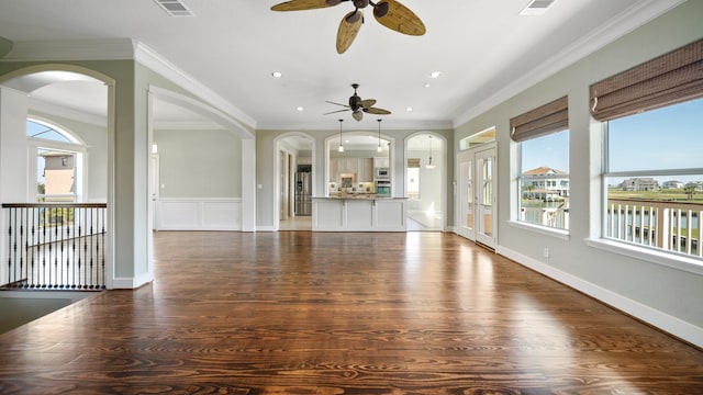 unfurnished living room with ceiling fan, ornamental molding, and dark hardwood / wood-style floors