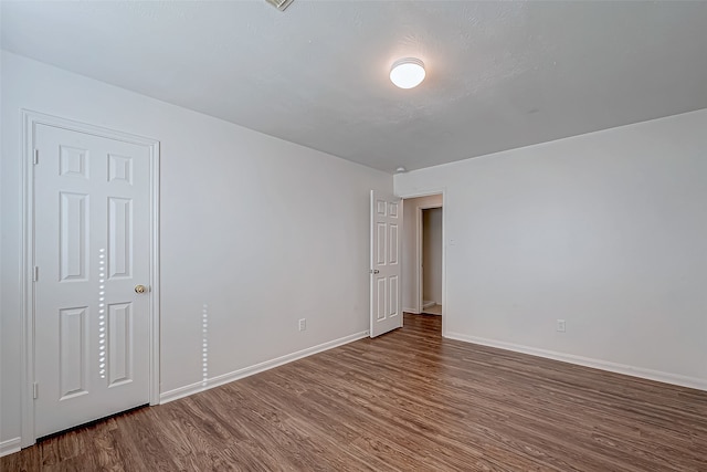 spare room with hardwood / wood-style flooring