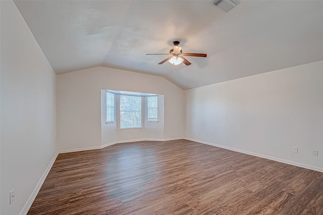 bonus room with dark hardwood / wood-style flooring, vaulted ceiling, and ceiling fan