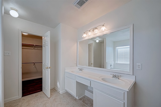 bathroom with tile patterned flooring and vanity