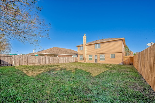 rear view of property featuring a yard