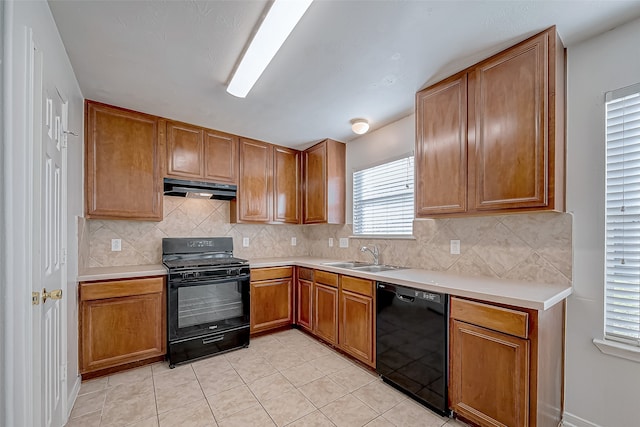 kitchen featuring black appliances, decorative backsplash, light tile patterned floors, and sink