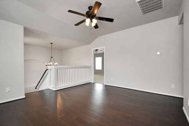 unfurnished room with dark wood-type flooring, vaulted ceiling, and ceiling fan with notable chandelier