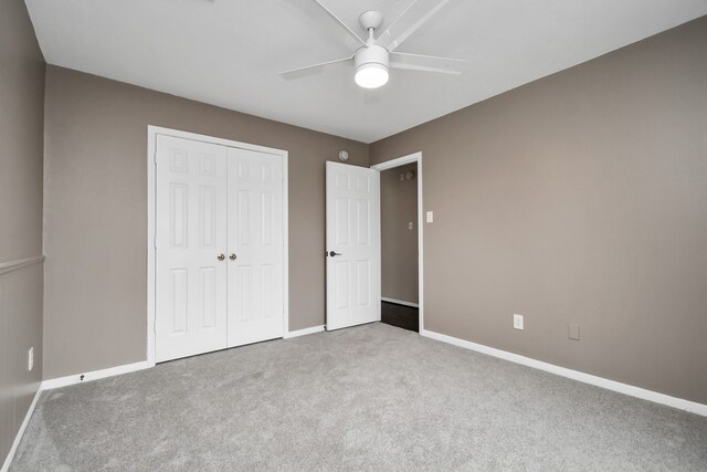 unfurnished bedroom featuring a closet, ceiling fan, and carpet