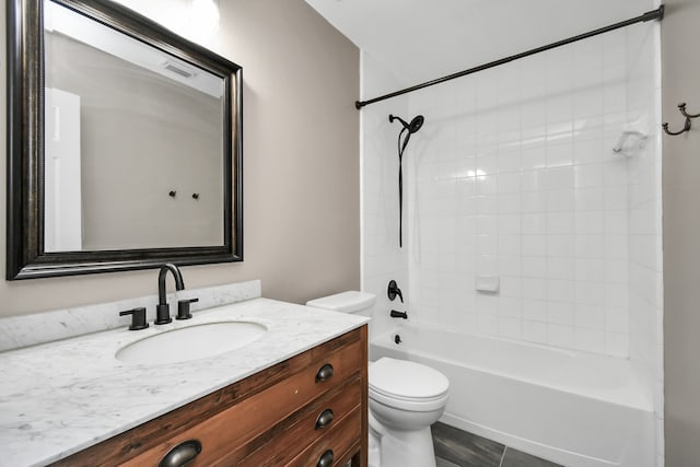 full bathroom featuring vanity, toilet, and tiled shower / bath