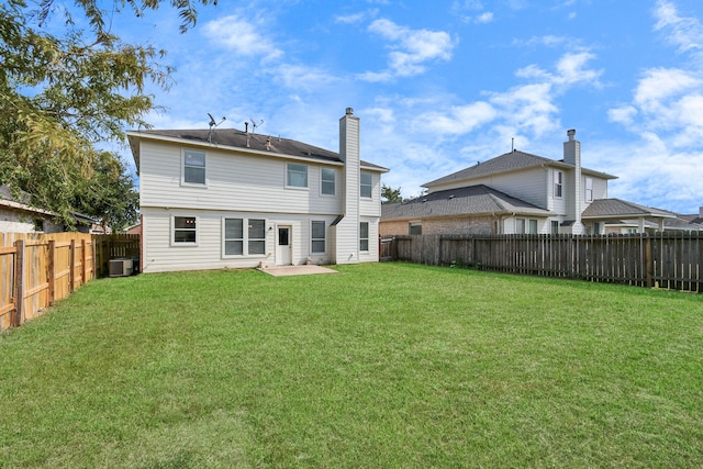 rear view of house featuring a yard, central air condition unit, and a patio area