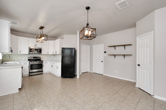 kitchen with sink, appliances with stainless steel finishes, decorative light fixtures, and white cabinetry