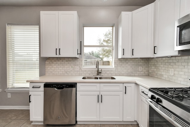 kitchen featuring a wealth of natural light, sink, and appliances with stainless steel finishes