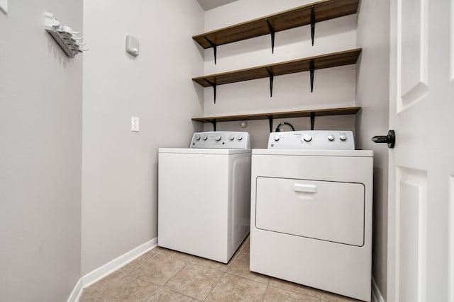 laundry room featuring light tile patterned flooring and separate washer and dryer