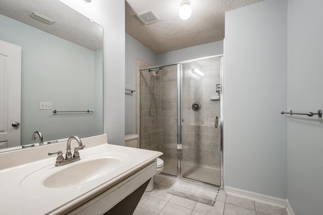 bathroom featuring tile patterned floors, an enclosed shower, a textured ceiling, sink, and toilet