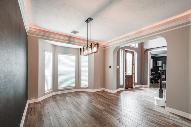 entryway with crown molding and wood-type flooring