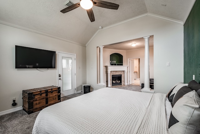 bedroom with carpet, vaulted ceiling, ceiling fan, ornamental molding, and a fireplace