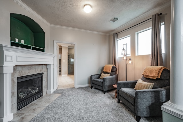 sitting room featuring a fireplace, light carpet, a textured ceiling, and crown molding