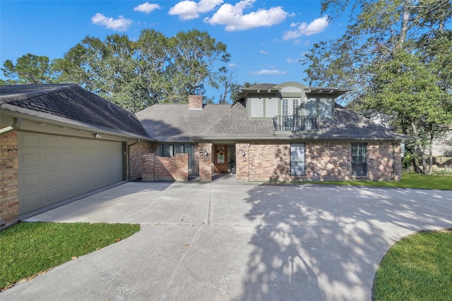 view of front of house with a balcony and a garage