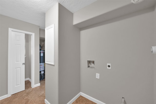 washroom with electric dryer hookup, washer hookup, a textured ceiling, and water heater